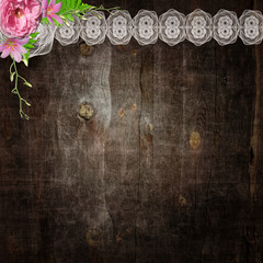 White lace and flowers on the wooden background