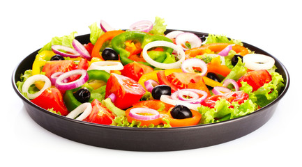 many vegetables in a pan isolated on white