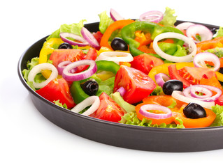 many vegetables in a pan isolated on white