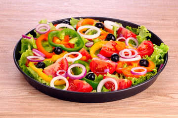 many vegetables in pan on  wooden background