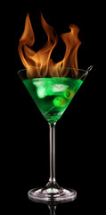 Burning Martini drink isolated on black background