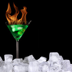 Burning Martini drink isolated on black background