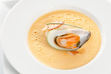 Carrot soup with seafood on white background