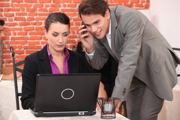 Young couple using a laptop computer in a restaurant
