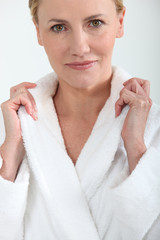 Woman in bath robe holding collar