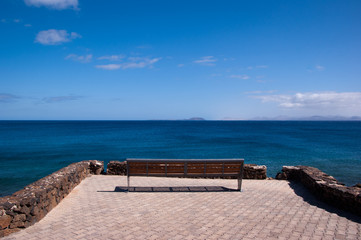lonly empty bench in playa blanca overlooking fuerteventura © chapeau77
