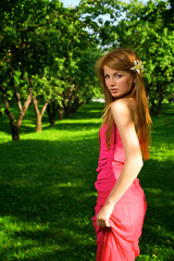 Fototapeta premium Young beautiful girl in apple orchard