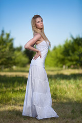 Fototapeta na wymiar Beautiful young blonde woman in park