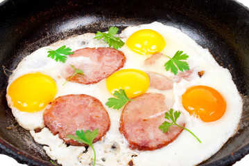 Scrambled eggs with sausage on pan