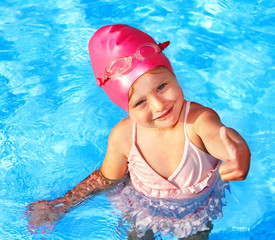 Child swimming in pool.