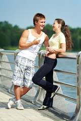 Young man and woman relaxing after jogging