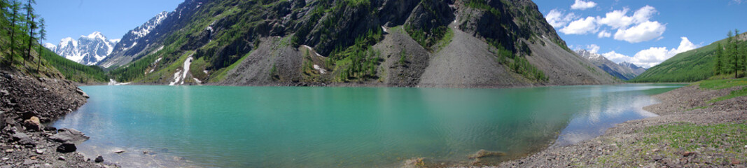 Fototapeta na wymiar Mountain lake in background with high mountain