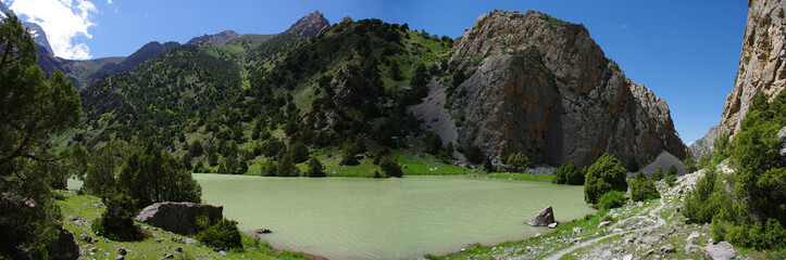 Fototapeta premium Mountain lake in background with high mountain
