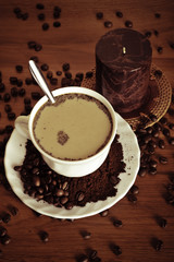 warm cup of coffee on brown background