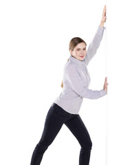 young woman pushing against wall or sign
