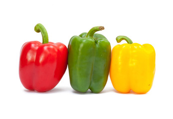Three sweet peppers in yellow, red and green color
