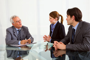 two men and one woman during a job interview