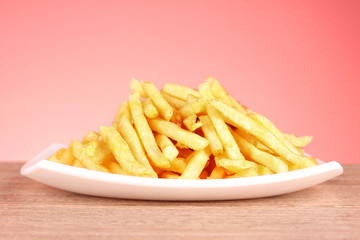 French fries and a plate on a red background