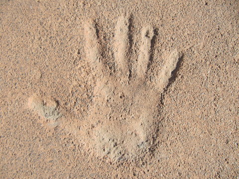 Hand print on cement.