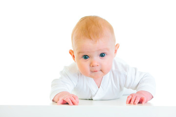 Interested  four month old  baby girl laying on abdomen.