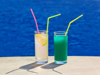 Two cocktails on marble table at beach