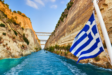 Corinth channel in Greece and greek flag on ship - obrazy, fototapety, plakaty