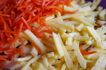 Closeup of grated Korean red carrots and chopped cheese