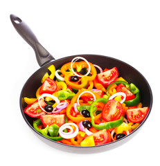 many vegetables in the pan isolated on white