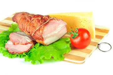 Arrangement with meat smoked bacon, tomatoes and cheese