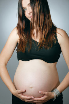 Beautiful pregnant woman with long hair.