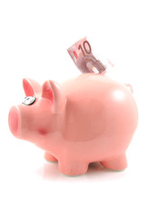 Piggy bank with euro money over white background