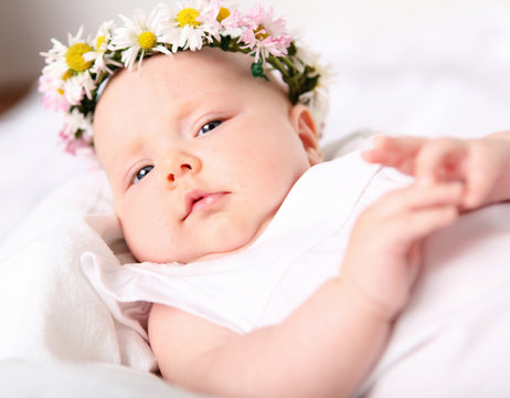 Portrait of a baby with a wreath