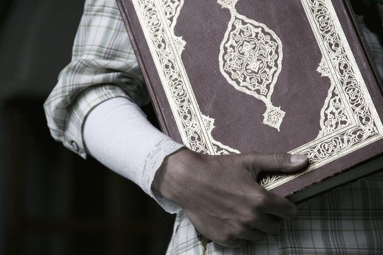 Girl holding a Koran