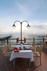 Romantic restaurant by the sea at sunset.