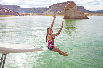 Woman playing at the lake on a waterslide