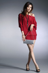 Fashionable young woman with handbag