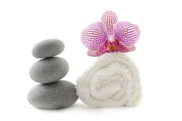 Spa stacked of stones and pink on towel