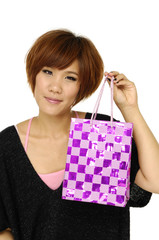 Cheerful girl with a gift box on white background