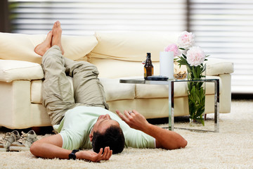 man relaxing in the living room, feet up