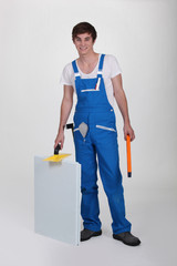 Studio shot of a young plasterer and equipment