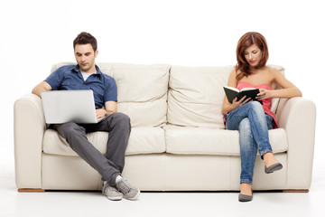 cuple sitting with book and laptop