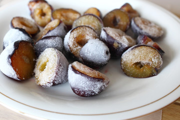 Frozen, defrosting plums on a plate