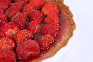 Strawberry Tart in a tart pan on a white background