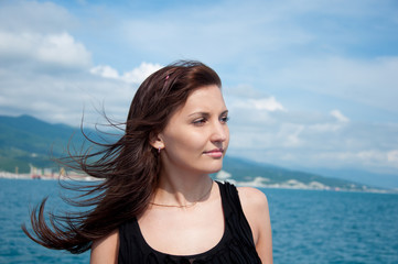 A beautiful young woman on a yacht at sea