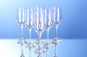 Few empty wine glasses on blue background