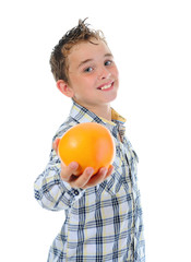 Little kid holding fresh oranges.