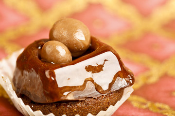 Beautiful little cake on colorful wallpaper background