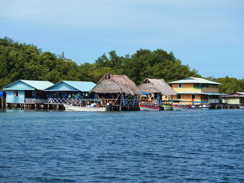 Over the water tropical restaurant with boats at dock, Caribbean sea, Bocas del Toro, Panama, Central America