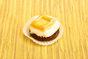 Beautiful little cake on colorful wallpaper background