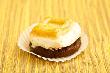 Beautiful little cake on colorful wallpaper background